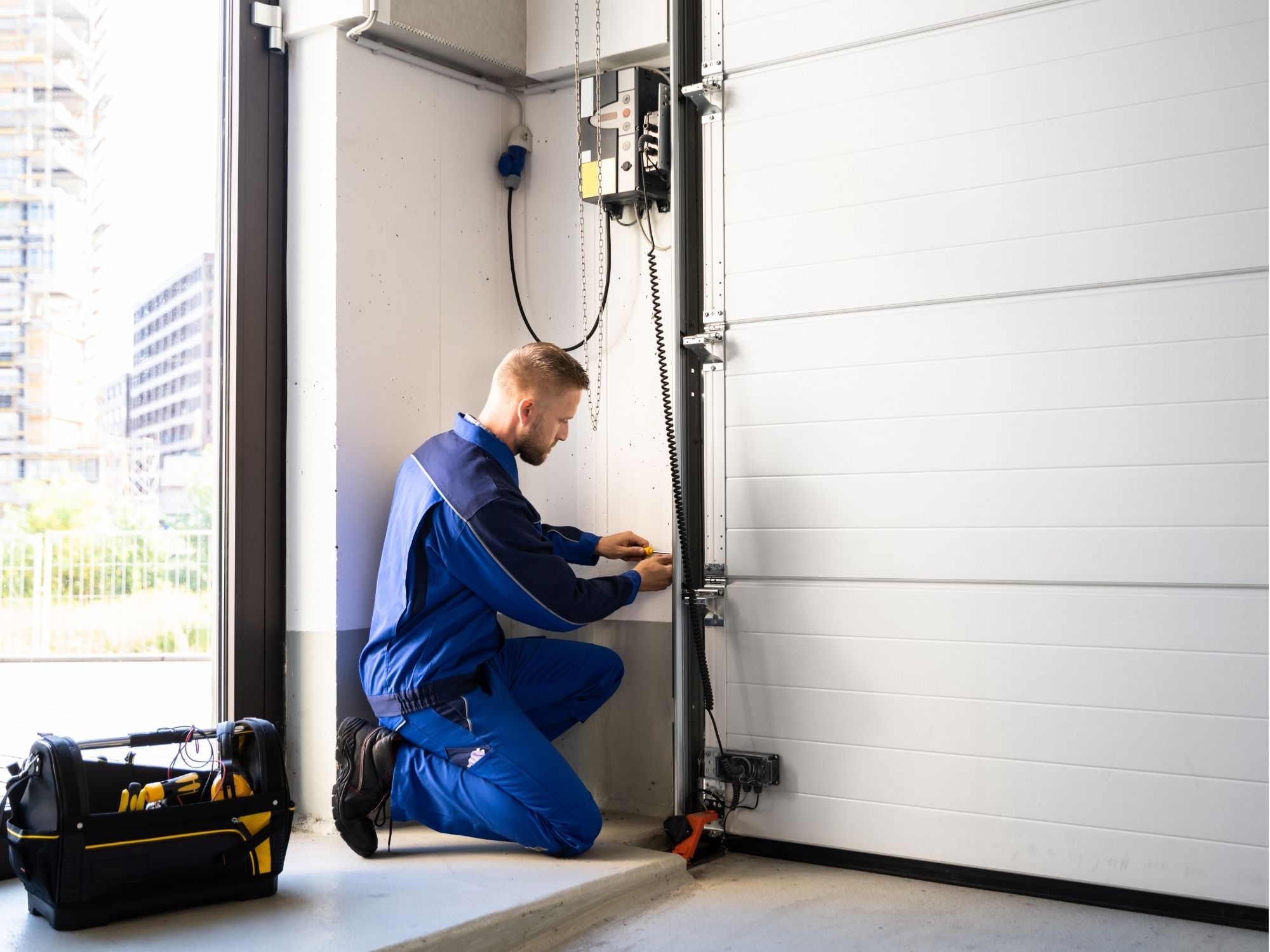 Garage door repair technician working on a residential overhead door