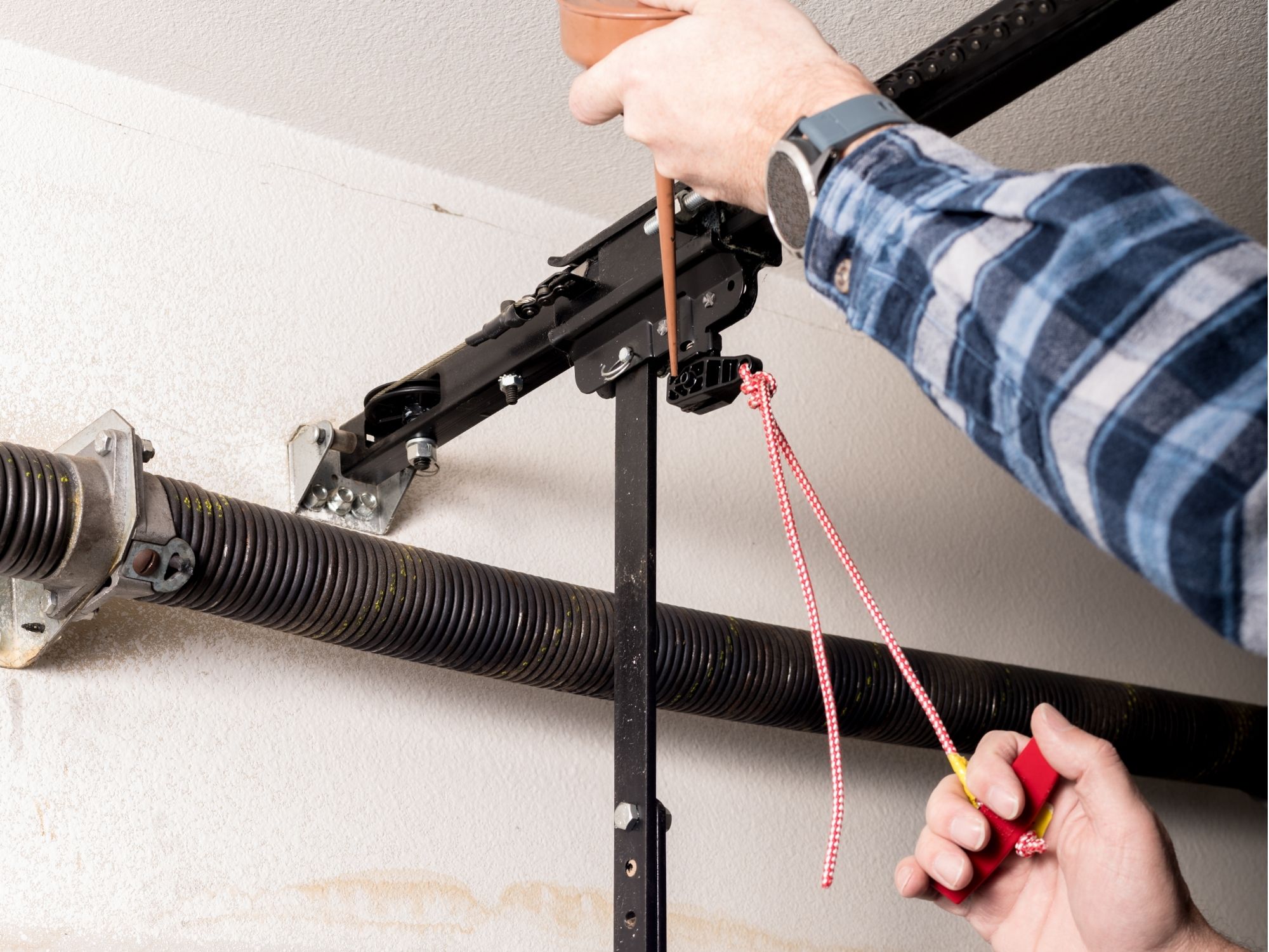 Garage door repair technician working on a residential overhead door