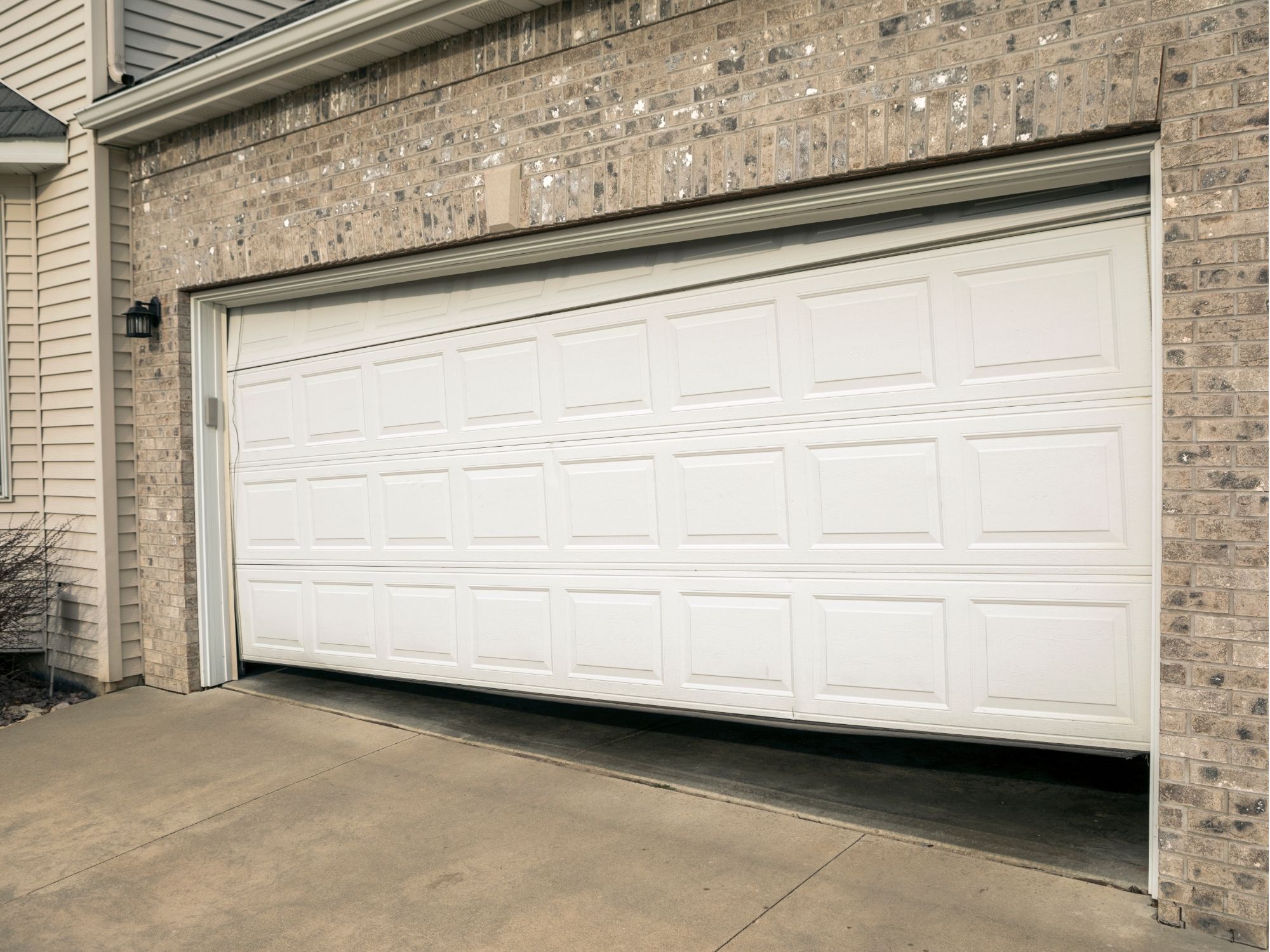 Residential garage door stuck partly open